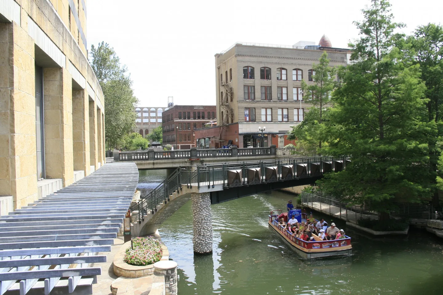San Antonio River Walk lined with trees and riverside architecture